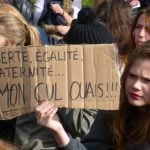 A high-school student carries a sign saying: "Liberté, Egalité, Fraternité...yeah right, my arse!"Photo: The Local
