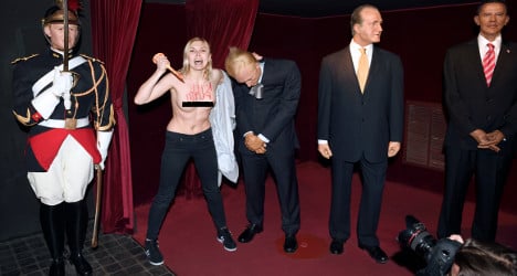 Topless feminist stabs wax Putin in France