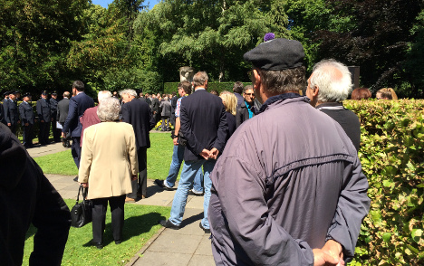 People in the cemetery in former West Berlin where victims are buried. Photo: Matty Edwards