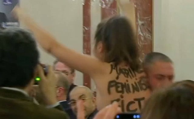 Topless woman disrupts Marine Le Pen speech and calls her a ‘pretend feminist’