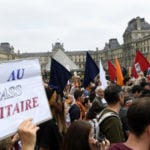 French vaccination centres vandalised as thousands protest health restrictions