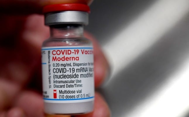 A person holds a vial of Moderna Covid-19 vaccine in France