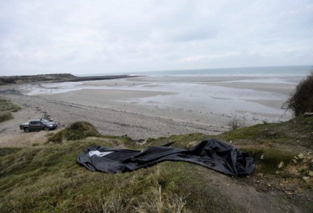 This picture shows a torn dingy boat near the beach of Wimereux, on the northern coast of France, from where migrants leave to cross the Channel on inflatable boats in an attempt to reach England.