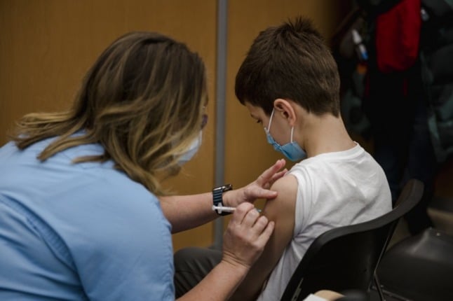 A child, aged 11, receiving a Covid-19 vaccine